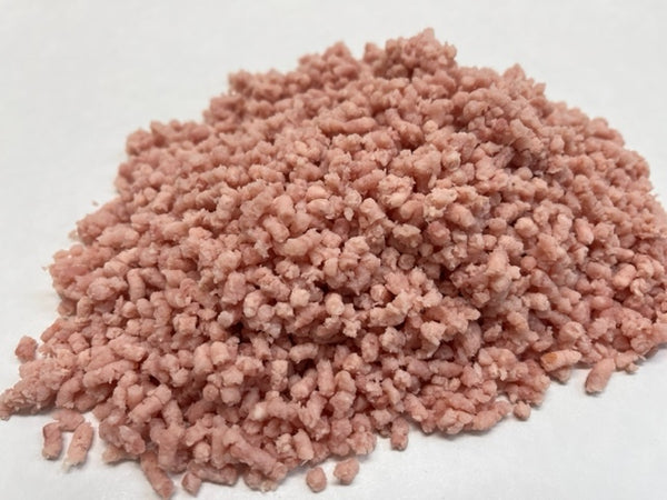 A pile of ground pork meat on white butcher paper
