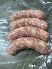 fresh brats with Jalapeño on a clear plastic surface