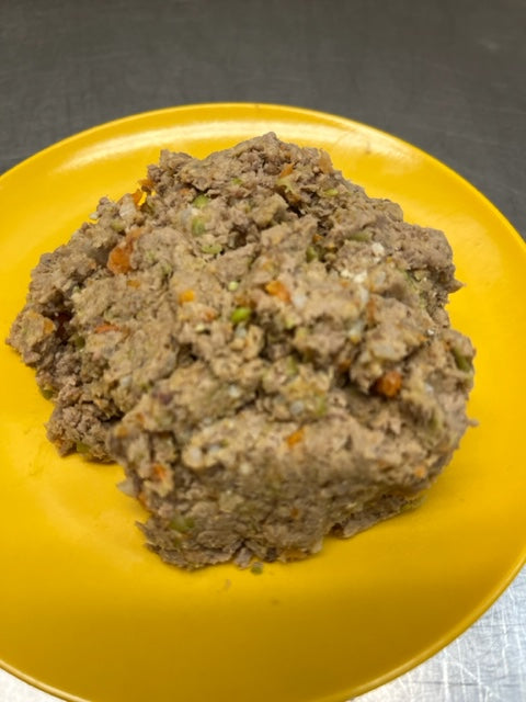 A pile of beef dog food on a yellow plate, with visible grains and seasonings.