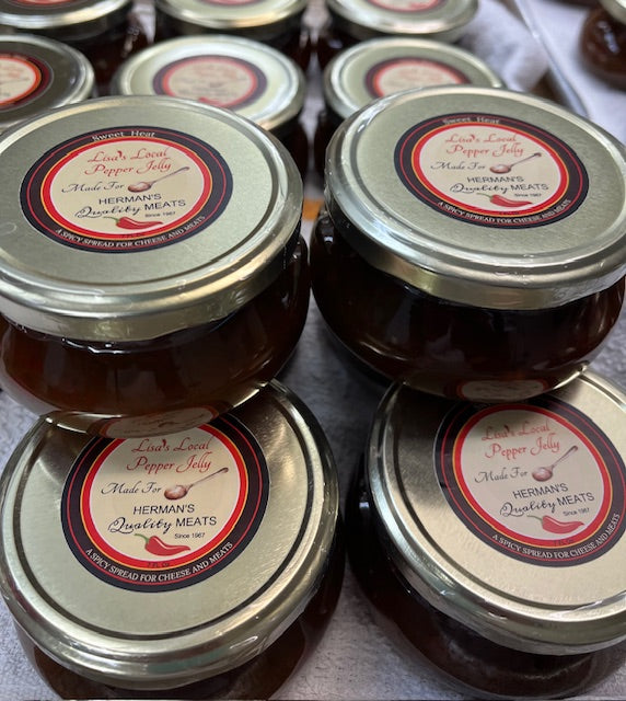multiple glass jars of Lisa's Local Pepper Jelly in case