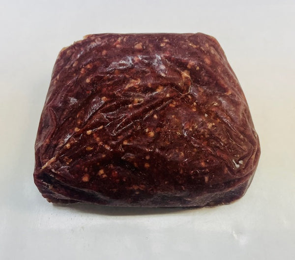 Square-shaped dark brown ground beef on a white background