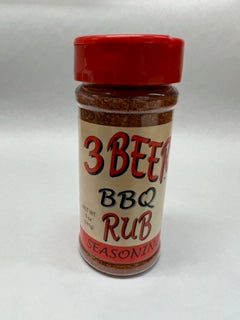 A bottle of 3 Bean BBQ Rub seasoning with a red cap and label that includes the product name and the word 'Seasoning'.