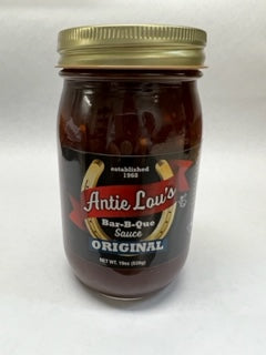 A jar of Antie Lou's Bar-B-Que Original sauce with a label that includes the product name and 'Antie Lou's Original Bar-B-Que Sauce.'.