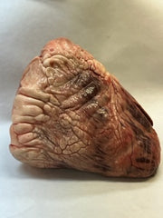 A raw beef heart on a white butcher paper.