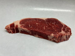 Bison strip steak on a butcher white sheet