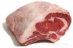 A bone-in beef rib roast with visible meat and bone structure, positioned on a white background.