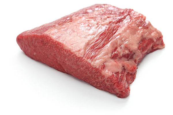 A raw beef brisket point off on white butcher paper