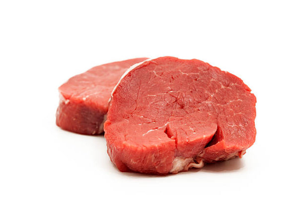 Two raw filet mignon steaks on a white background