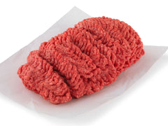Ground round  pile sitting on a plastic wrap paper with white background. 
