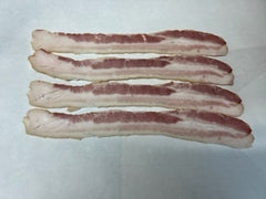 Raw slices of smoked bacon laid out on a flat surface.