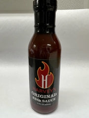 BBQ sauce bottle on a white flat surface. 