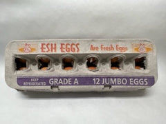 A carton of fresh eggs labeled 'ESH EGGS' with the grade A sticker, containing 12 jumbo eggs.