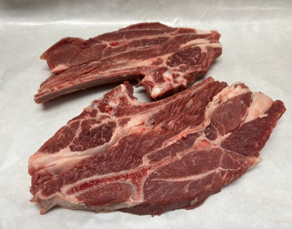 Raw lamb shoulder chops on white butcher paper