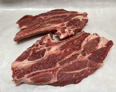 Raw lamb shoulder chops on white butcher paper