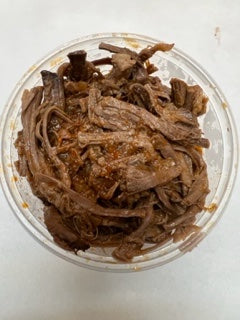 round plastic container with smoked seasoned shredded brisket 