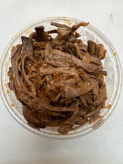 round plastic container with smoked seasoned shredded brisket 