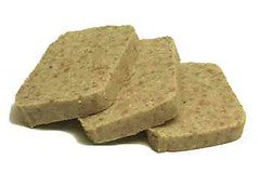 A photograph showing a stack of freshly prepared scrapple, a Pennsylvania Dutch specialty made from pork.