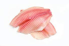 A pile of fresh tilapia fish fillets on a white background.