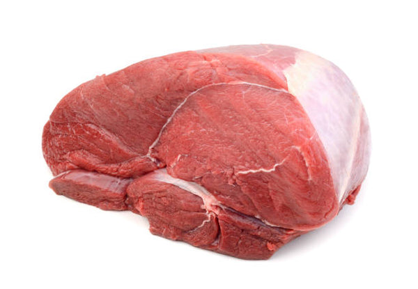 A fresh beef top round roast with a pink to red gradient, showing a side view of the meat.