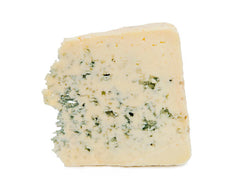 A wedge of blue cheese with a visible moldy blue surface area and a chunk broken out from the top.