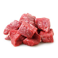 Fresh beef chuck stew cubes all sitting on a flat white background. 