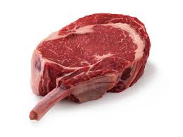 A single raw cowboy steak with a visible bone, isolated on a white background.