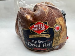 a package wrapped in plastic of Dietz & Watson Top Round Dried Beef  on white butcher paper
