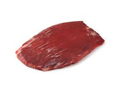 raw flank steak on white butcher paper