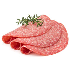 Several slices of Italian salami with a sprig of rosemary on top, against a white background.