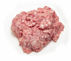 A pile of fresh ground lamb on a white butcher paper.