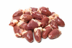 Raw chicken heart cubed in a group on white background