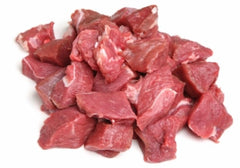 a pile of lamb cubes on white butcher paper