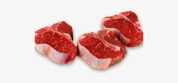 Several lamb loin chops on a white butcher paper. Displaying the meat's texture and color.