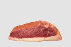 A raw Picanha steak, also known as top sirloin cap or rump cap, isolated on a white background.