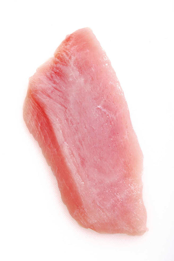 A single pink turkey cutlet against a white background.