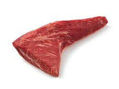 A single slice of raw beef tri-tip roast meat on white butcher paper