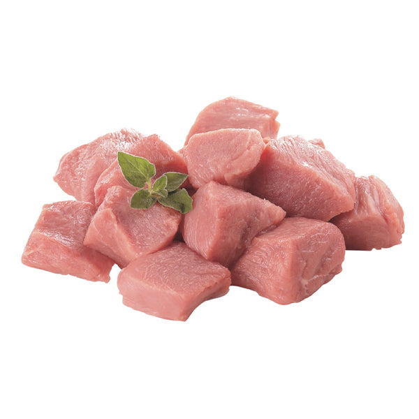Cubed pieces of fresh veal stew with a small sprig of thyme on top.