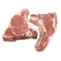 Two veal rib chops with visible bone and meat, separated by a white background.