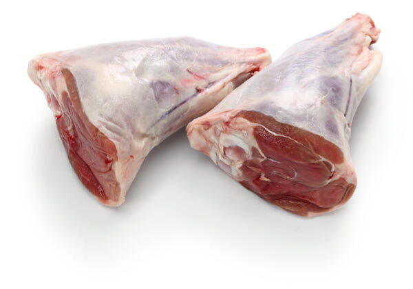 Raw veal shank on a white flat surface. 
